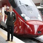Luca Cordero di Montezemolo, president for the NTV, waves as he poses in front of the new high-speed train “Italo” at the Naples central station